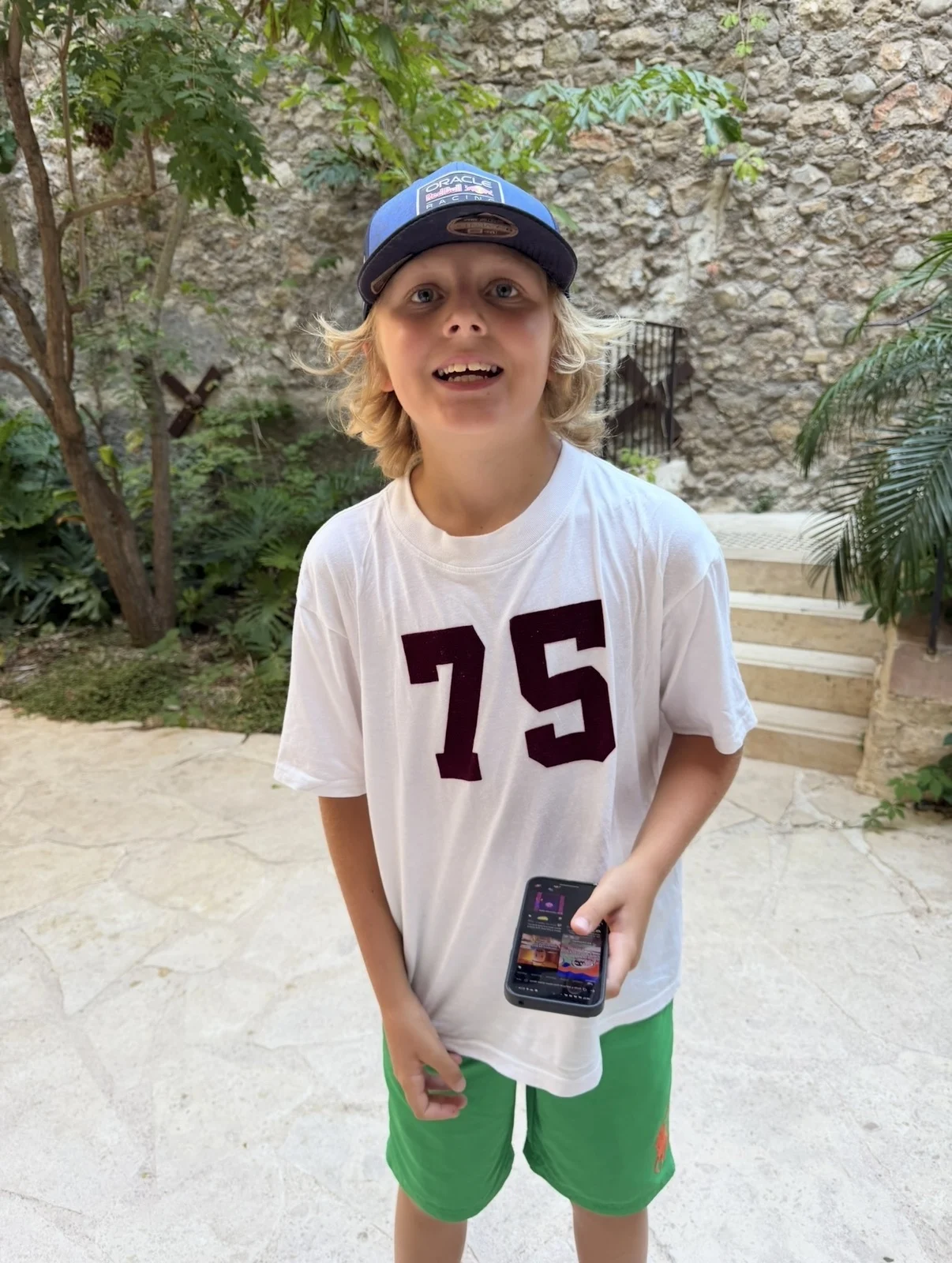 Rocco speaking to camera while holding a phone